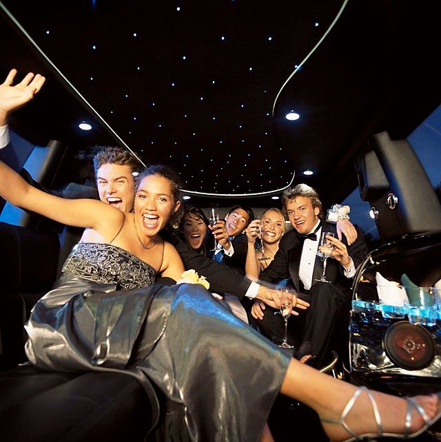 A group of people are posing for a picture in a limousine
