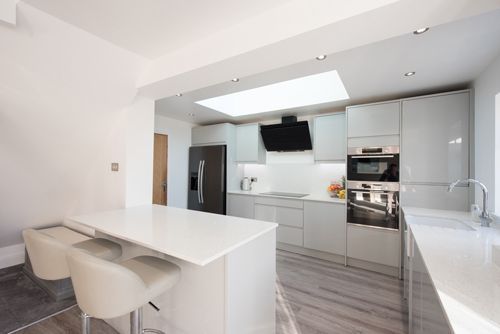 Modern kitchen featuring elegant stone benchtops and stainless steel appliances in bright space. — Melbourne, VIC — The AU Stone Company
