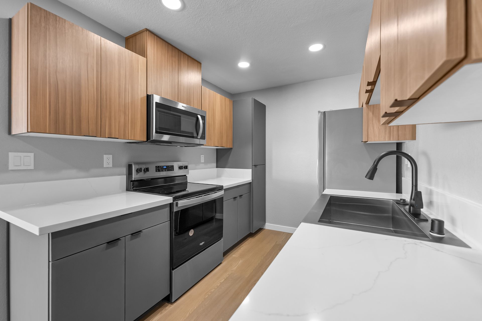 Unfurnished kitchen with stoke and microwave