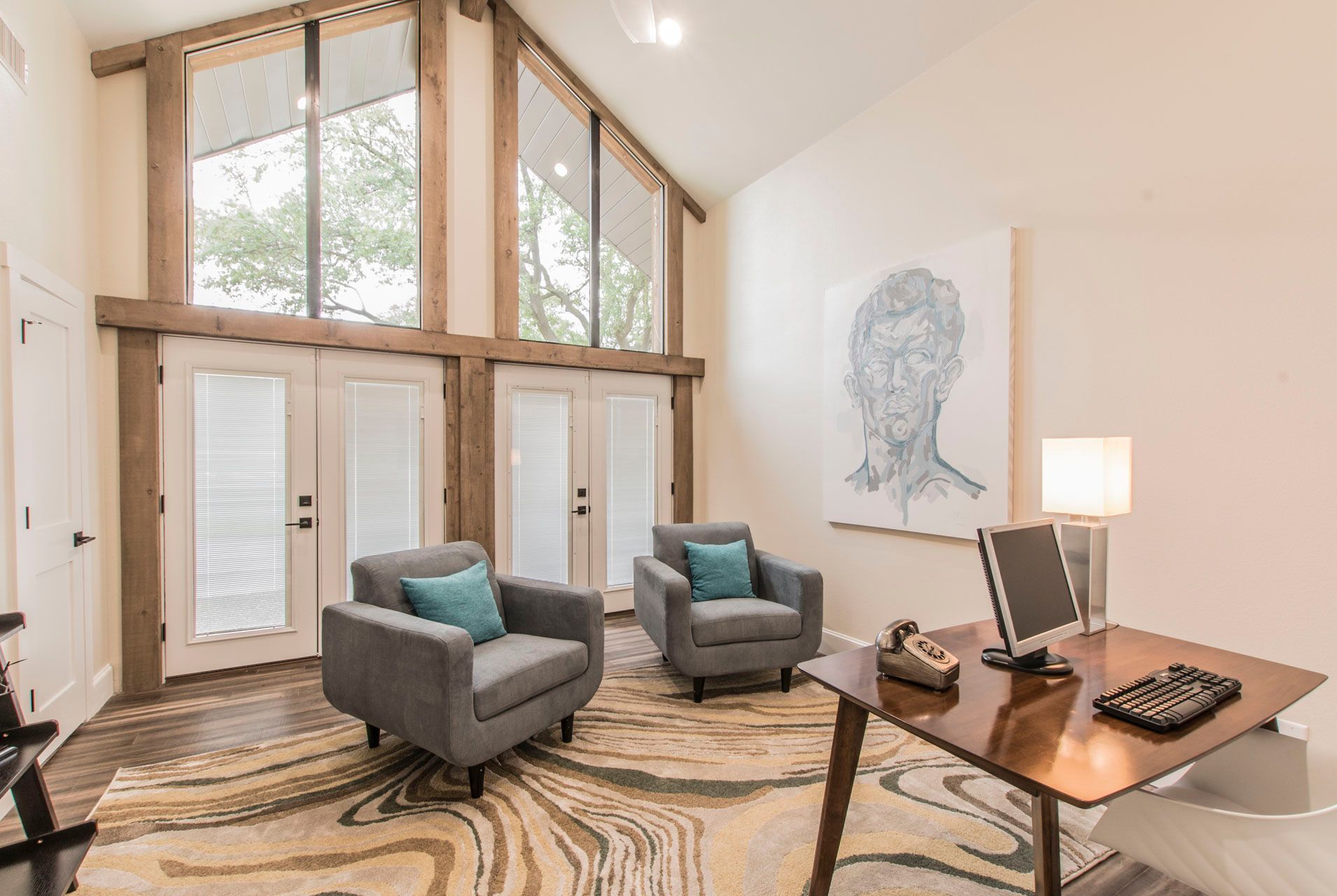 Office renovation in Southlake, TX, by Night 'N' Day Construction, featuring structural changes to front windows and doors, new flooring, paint, lighting, cedar beams and casings.