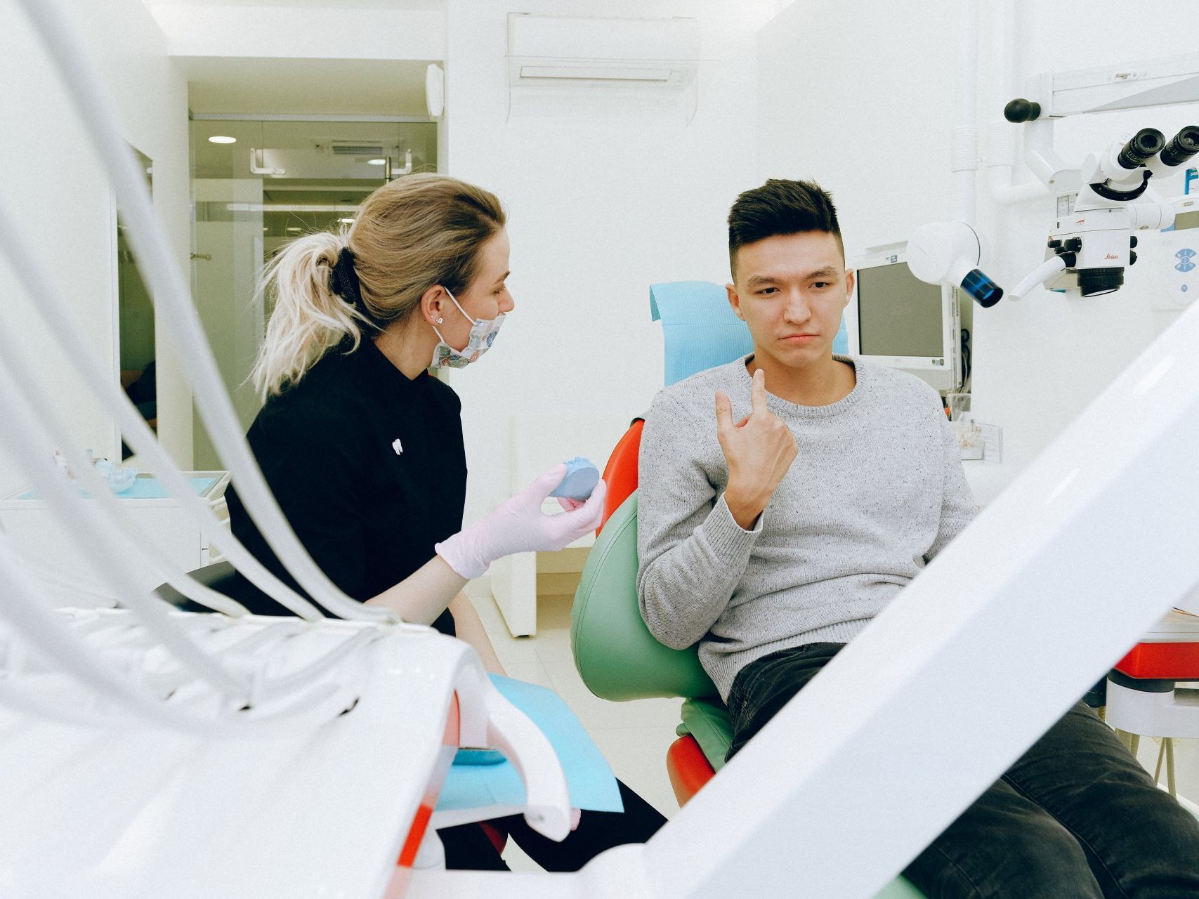 patient talking with dental assistant reviewing the patients concerns for periodontics