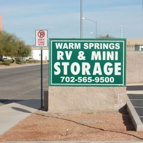 Sign for Warm Springs RV & Mini Storage in green and white, with a no-parking sign.