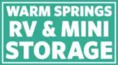 Warm Springs RV & Mini Storage sign in white text on a turquoise background.
