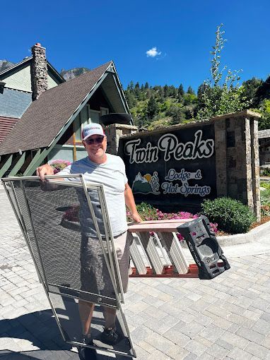 A man is standing in front of a sign that says twin peaks.