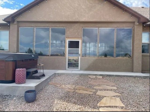 A house with a hot tub in front of it