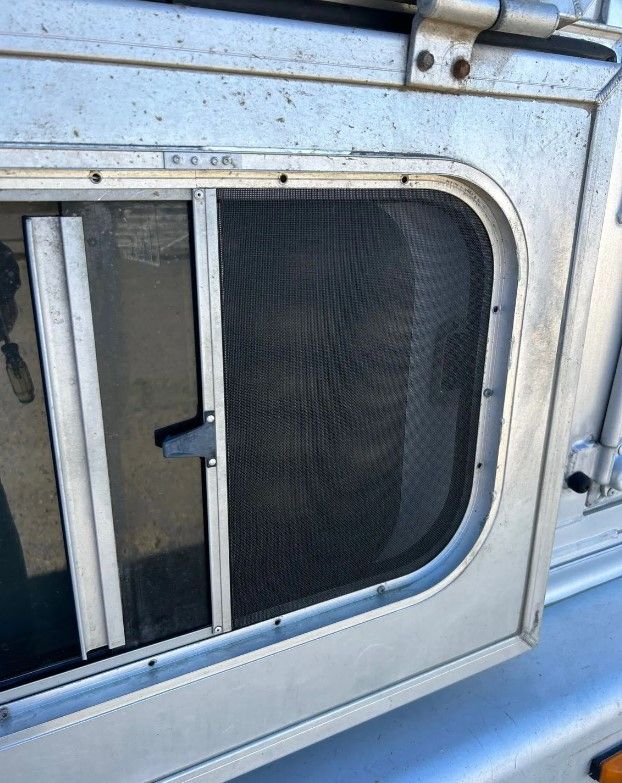A close up of a window on a trailer with a screen on it.