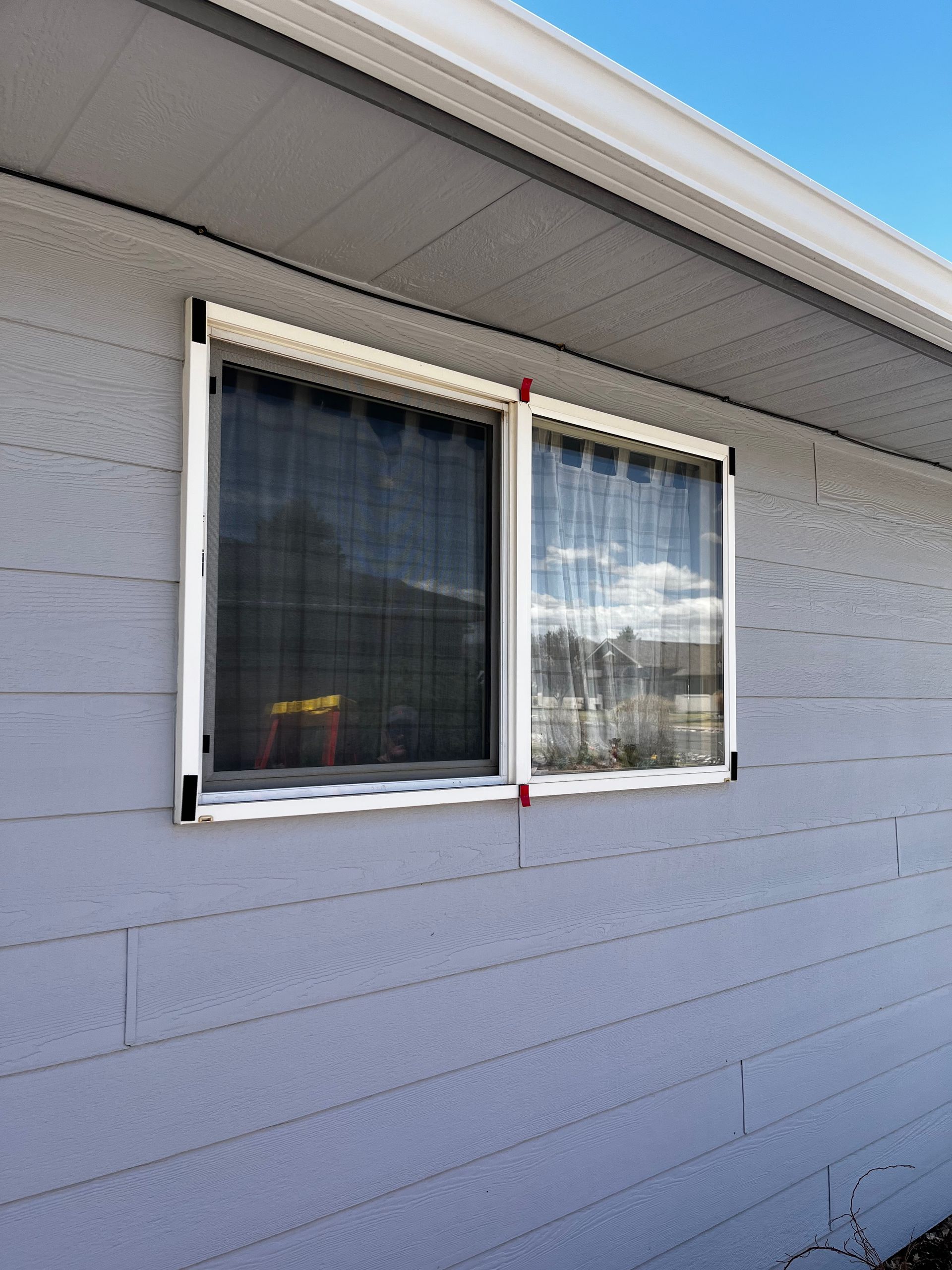 A house with two windows on the side of it