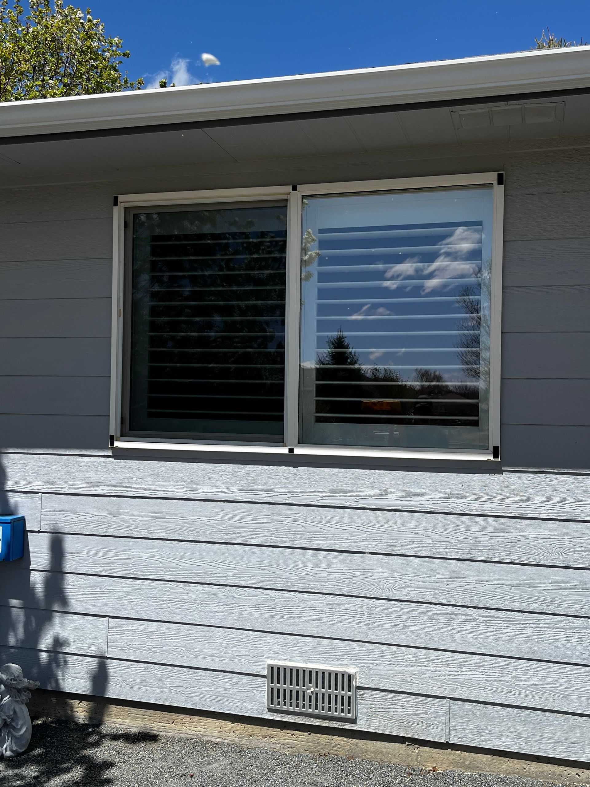 A house with a window and blinds on it