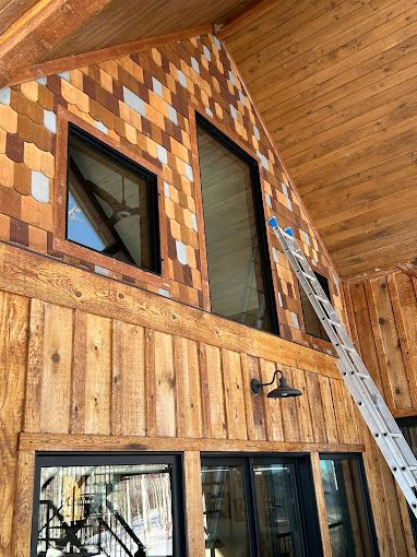 A ladder is hanging from the ceiling of a wooden building.