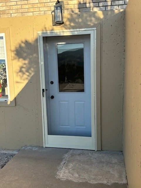 A white door with a screen on the side of it