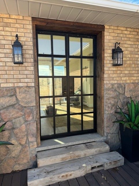 A brick building with a black door and steps