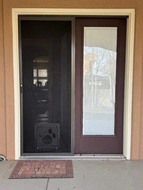 A sliding screen door with a paw print on it