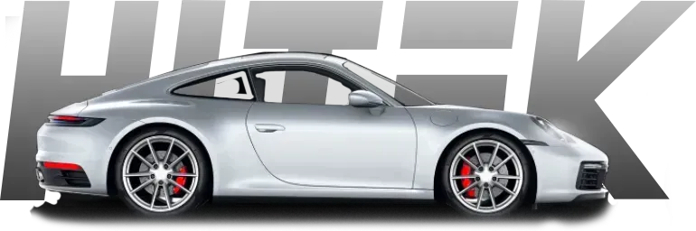 Silver Porsche sports car with red brake calipers, parked in front of gray 