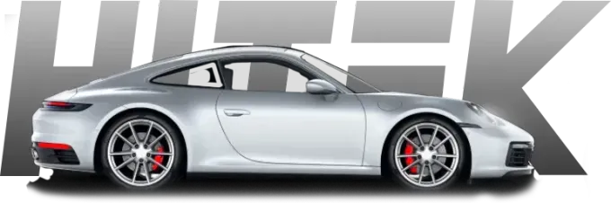 Silver Porsche sports car with red brake calipers, parked in front of gray 