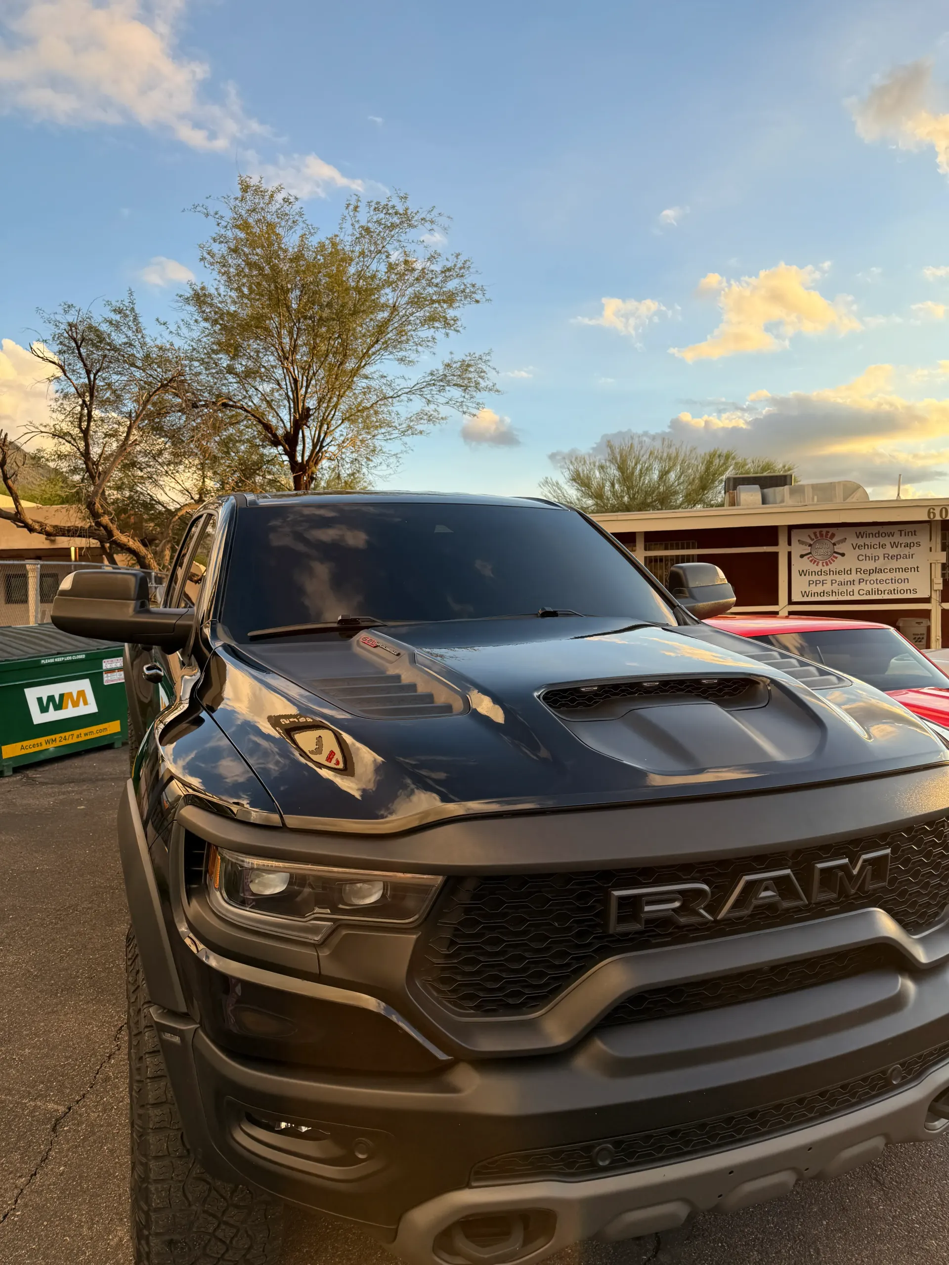Black Ram TRX truck with tinted windows, parked outside on a cloudy day.