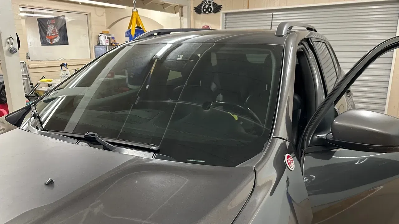 White lifted Ram pickup truck inside a garage with bright hexagon lights overhead.