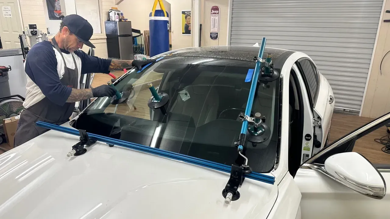 White lifted Ram pickup truck inside a garage with bright hexagon lights overhead.