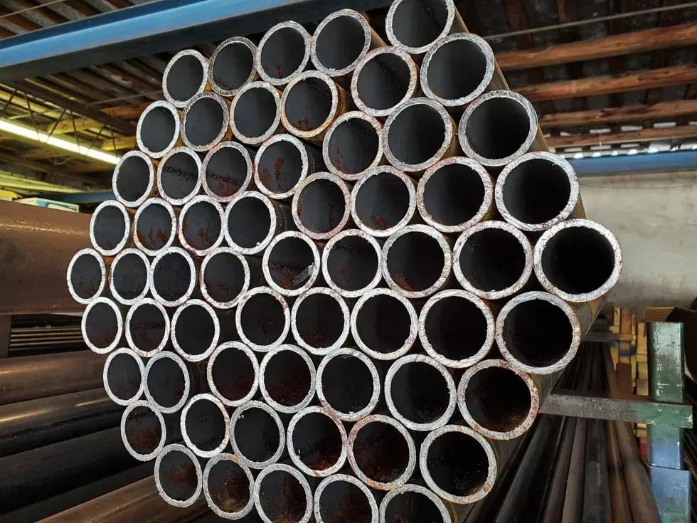 A bunch of metal pipes stacked on top of each other.