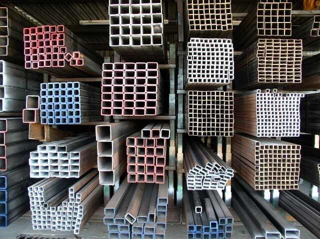 A bunch of square metal pipes stacked on top of each other.