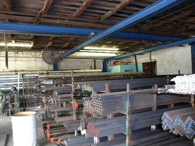 A warehouse filled with lots of metal tubes and pipes.