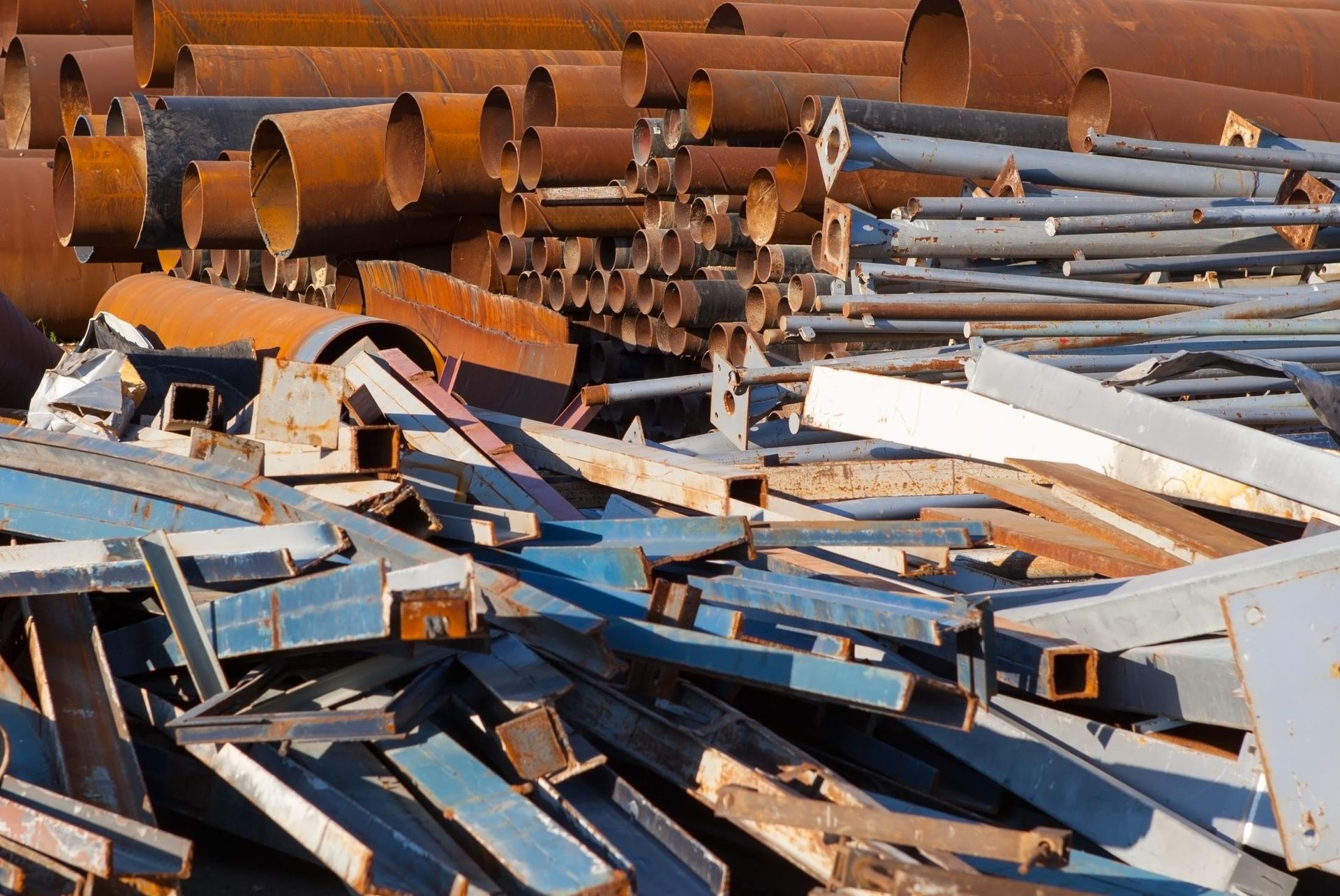 A pile of rusty metal pipes and pieces of wood