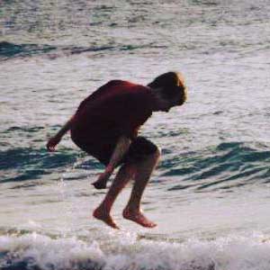 Child jumping in waves