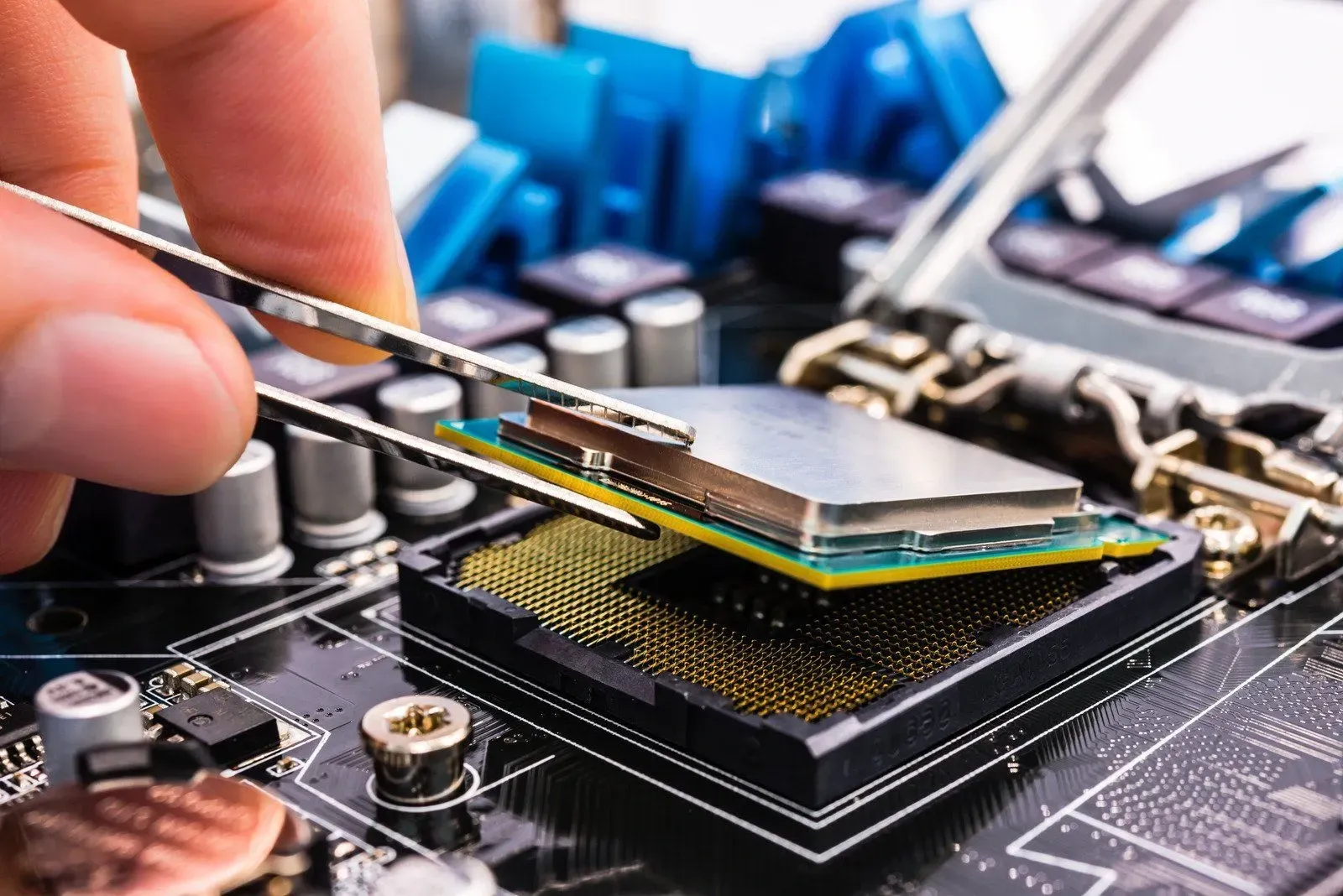 technician installing desktop pc cpu during onsite system upgrade using tweezers in Greensburg, Louisiana