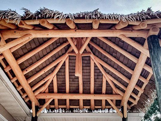 Wooden pergola with a thatched roof. Wooden pergola with a thatched roof.