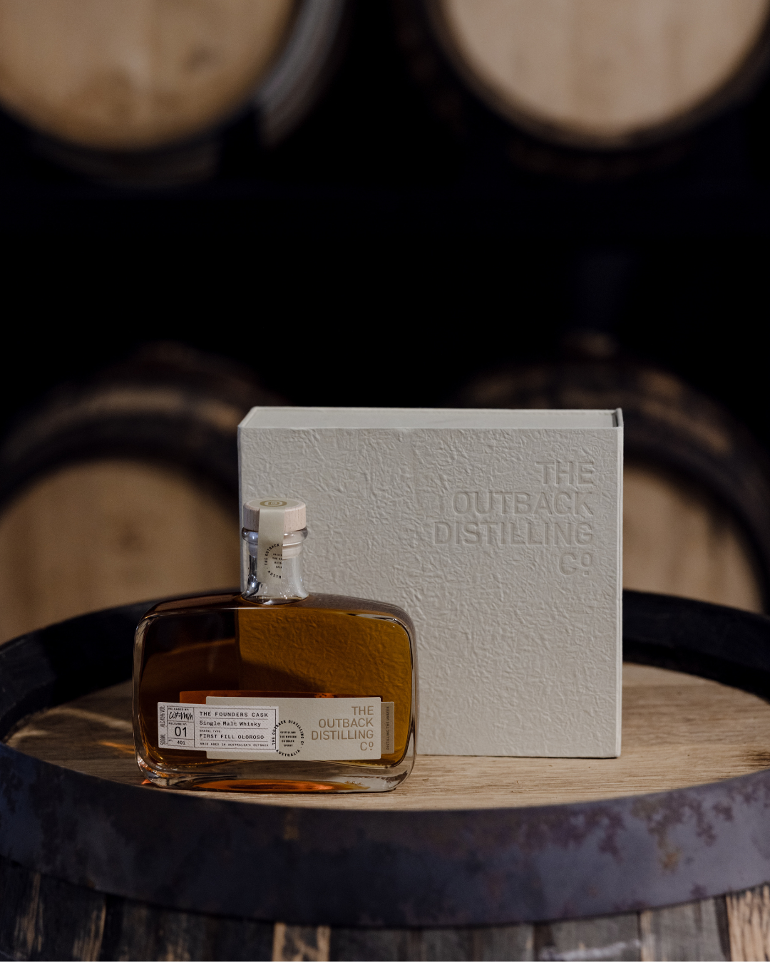 Australian single malt whisky by The Outback Distilling Co with gift box, displayed on barrel.