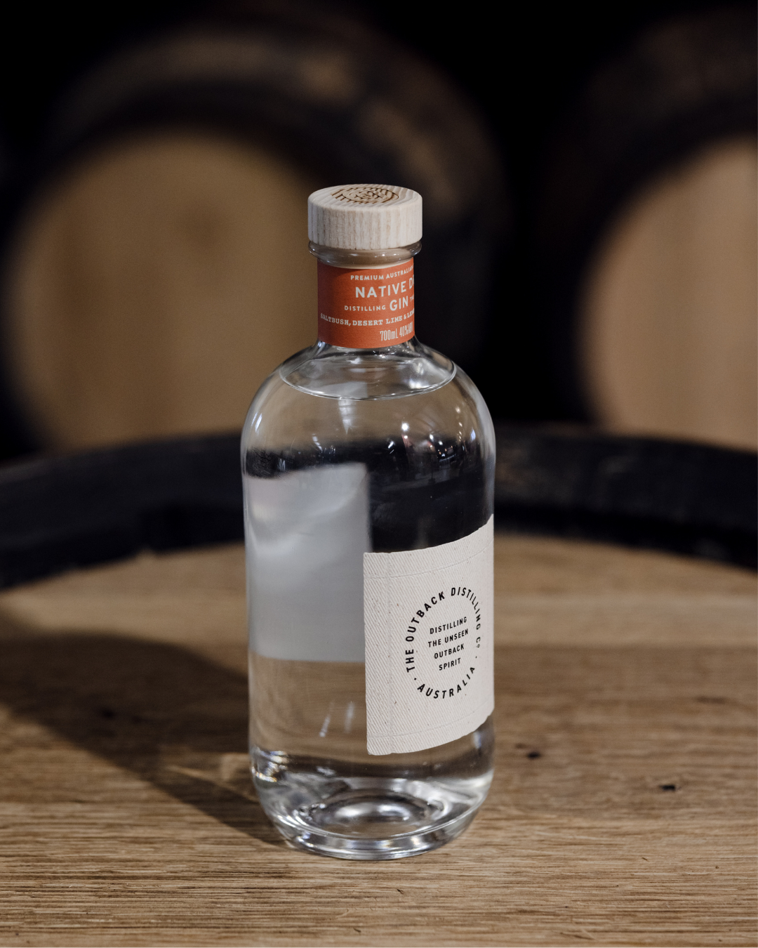 Australian Native Dry Gin by The Outback Distilling Co on barrel in distillery setting.