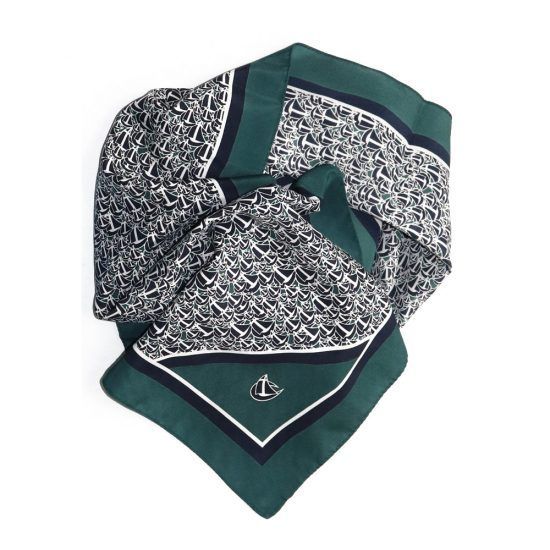 Green and white patterned silk scarf with navy borders and a logo in the corner.