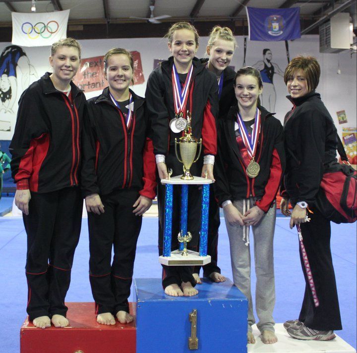 Gymnasts With Medals and Trophy