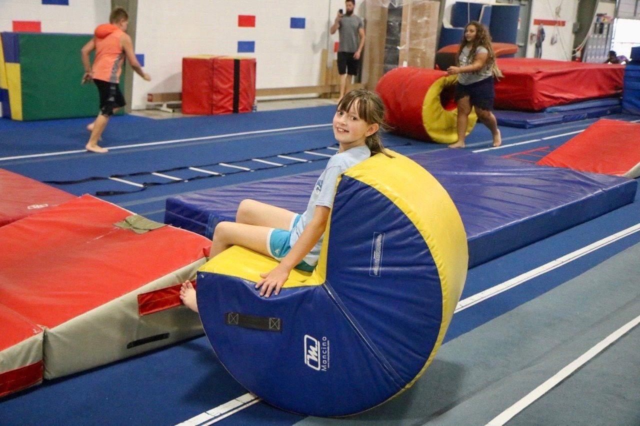 Girl Sitting on a Crescent Moon-Shaped Foam