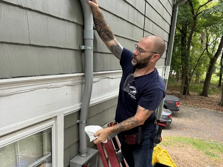 Electrician upgrading a residential electrical panel to handle modern power demands.