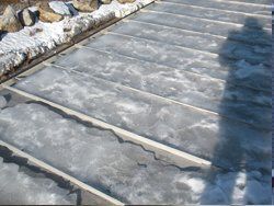 the roof of a building is covered in snow and ice .