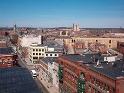 an aerial view of a city with a lot of buildings and a blue sky