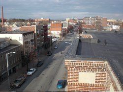 an aerial view of a city with a brick building in the foreground