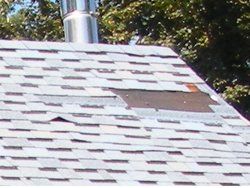 a roof with a hole in it and a chimney on top of it .