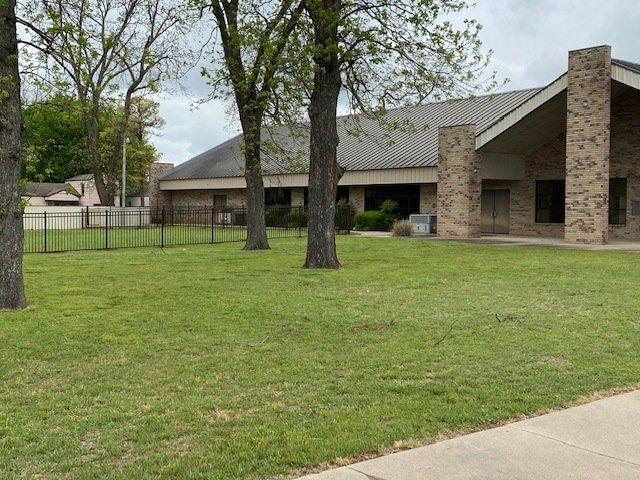 A large building with a large lawn in front of it