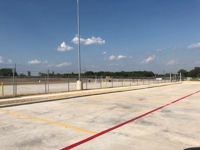 A parking lot with a red line on the side of it