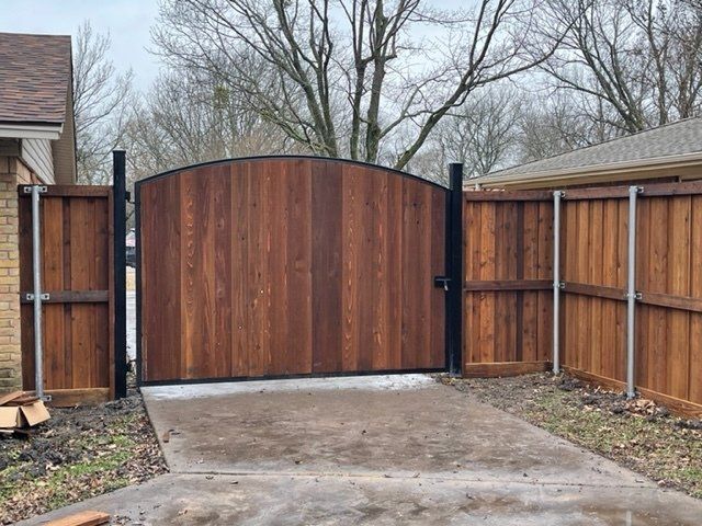 A wooden gate is surrounded by a wooden fence