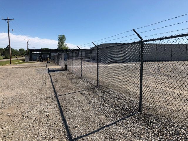 A chain link fence with barbed wire on top of it