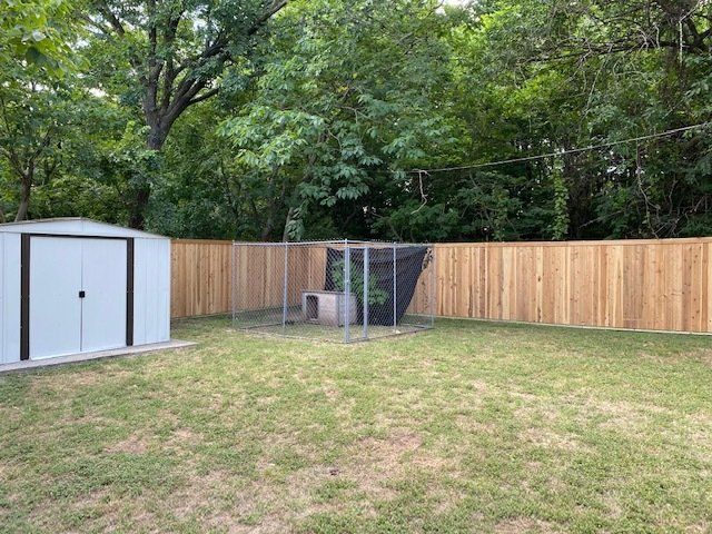 A backyard with a wooden fence and a shed.