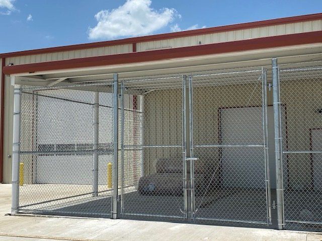 A chain link fence is in front of a building