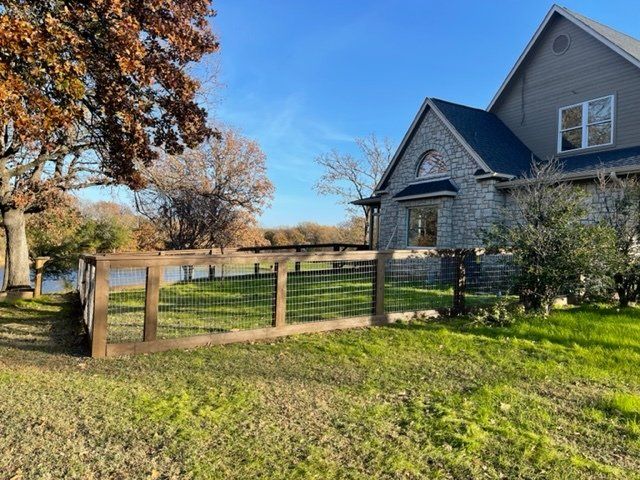 A house with a wooden fence in front of it