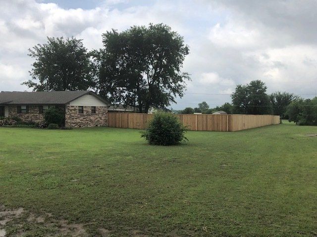 A house with a wooden fence in front of it