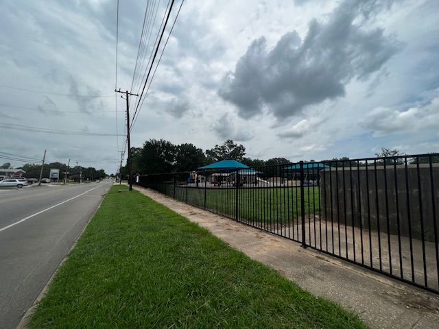 There is a fence along the side of the road.