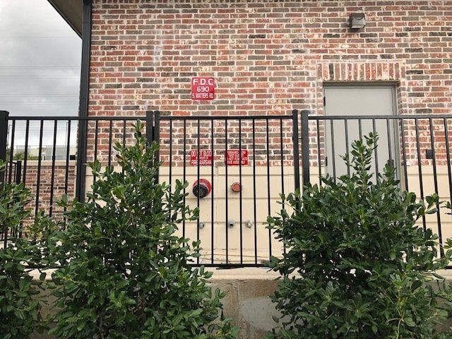 A brick building with a fire hydrant in front of it