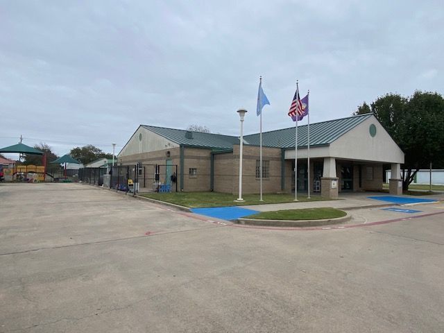 A large building with a lot of flags in front of it