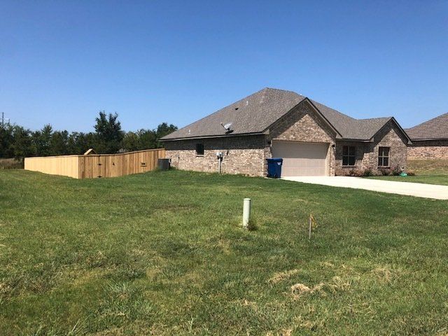 A house with a wooden fence in front of it